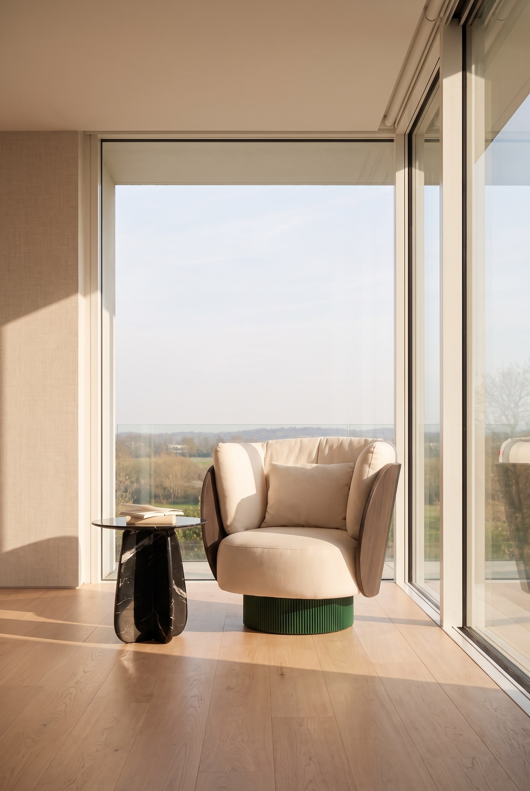 An elegantly placed swivel armchair in a bright, modern reading nook.