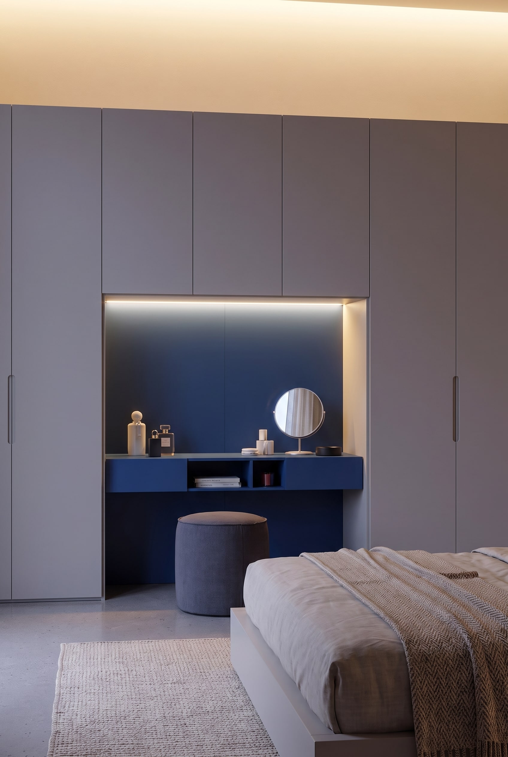 Front view of the midnight blue dressing niche framed by greige wardrobe doors.