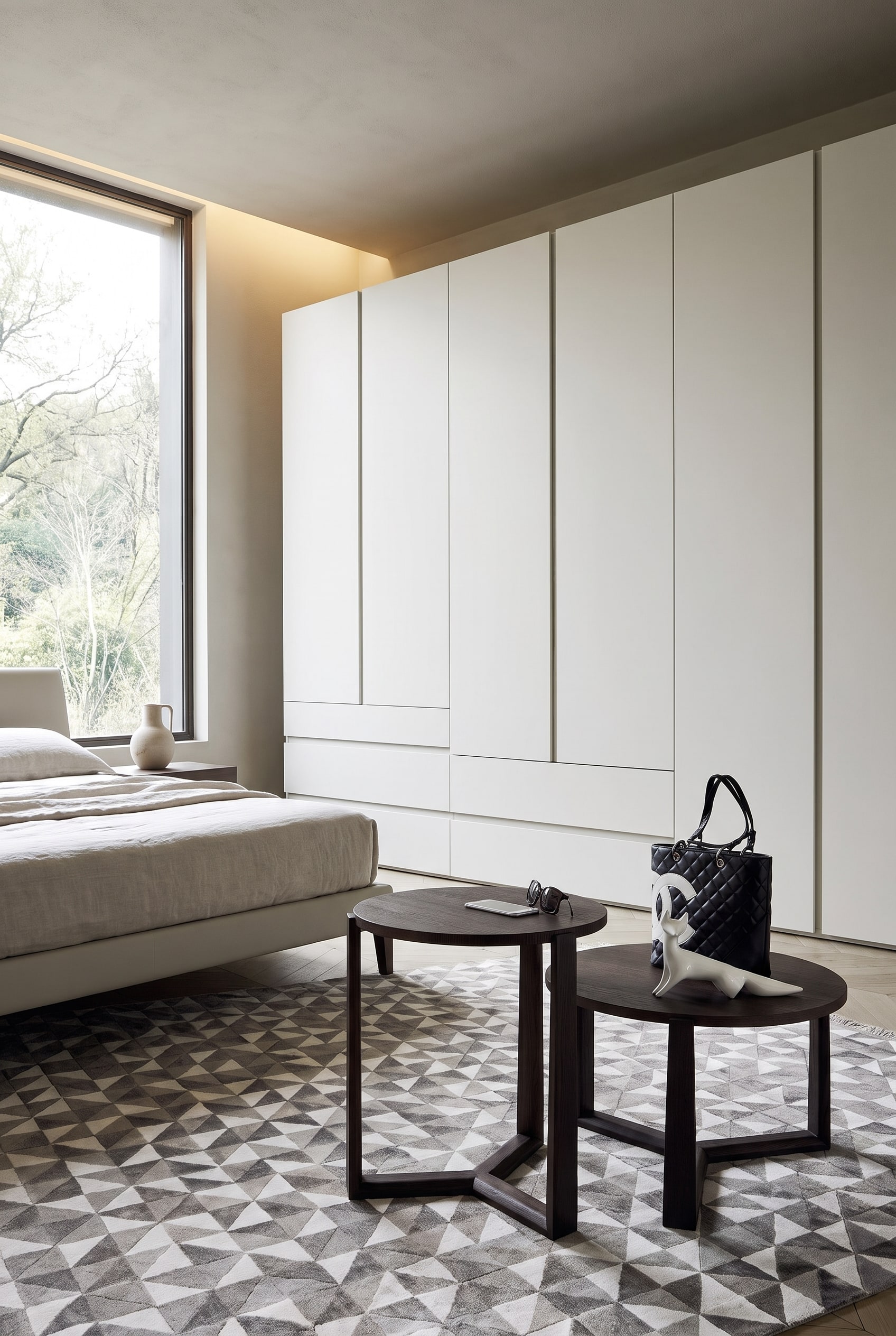 Elegant bedroom with custom-made Livitalia wardrobe with light matte fronts and asymmetrical lines