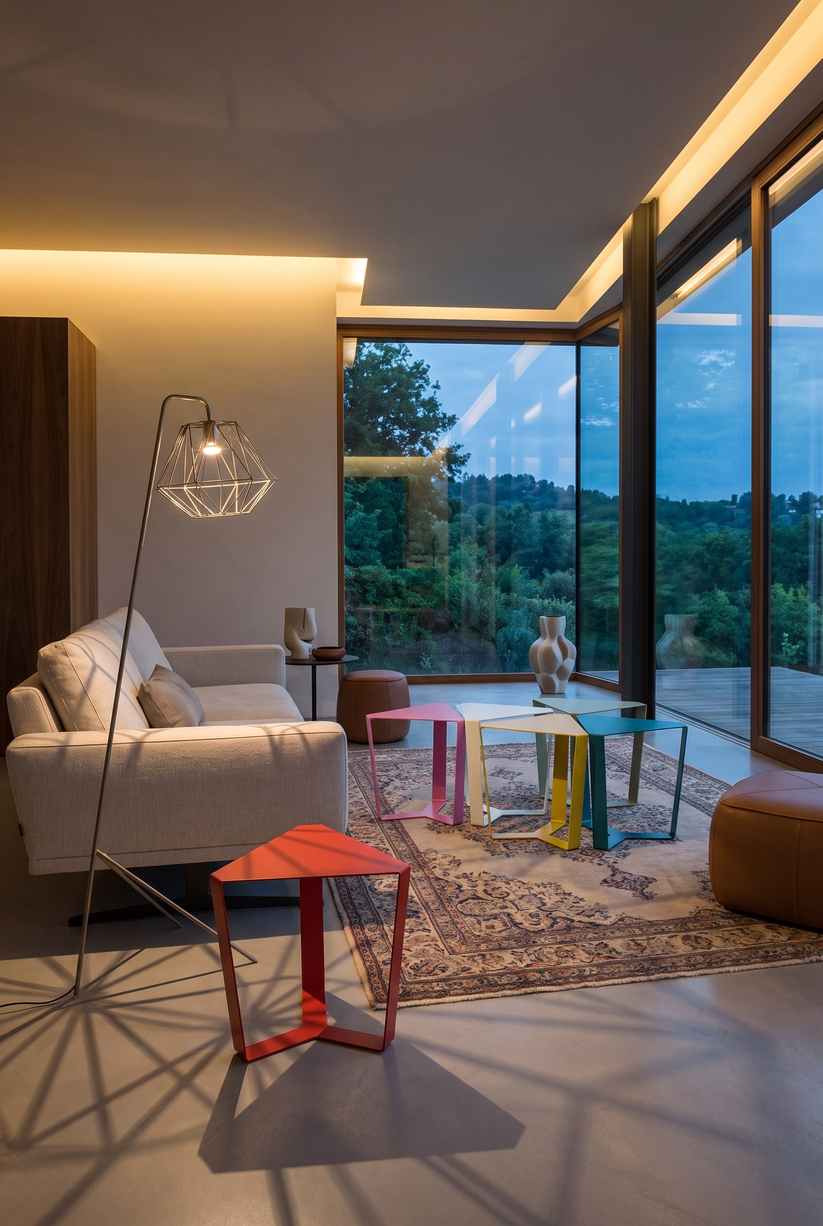 A bright living room with the Coral coffee table by Punt, whose open frame reveals a modern rug.