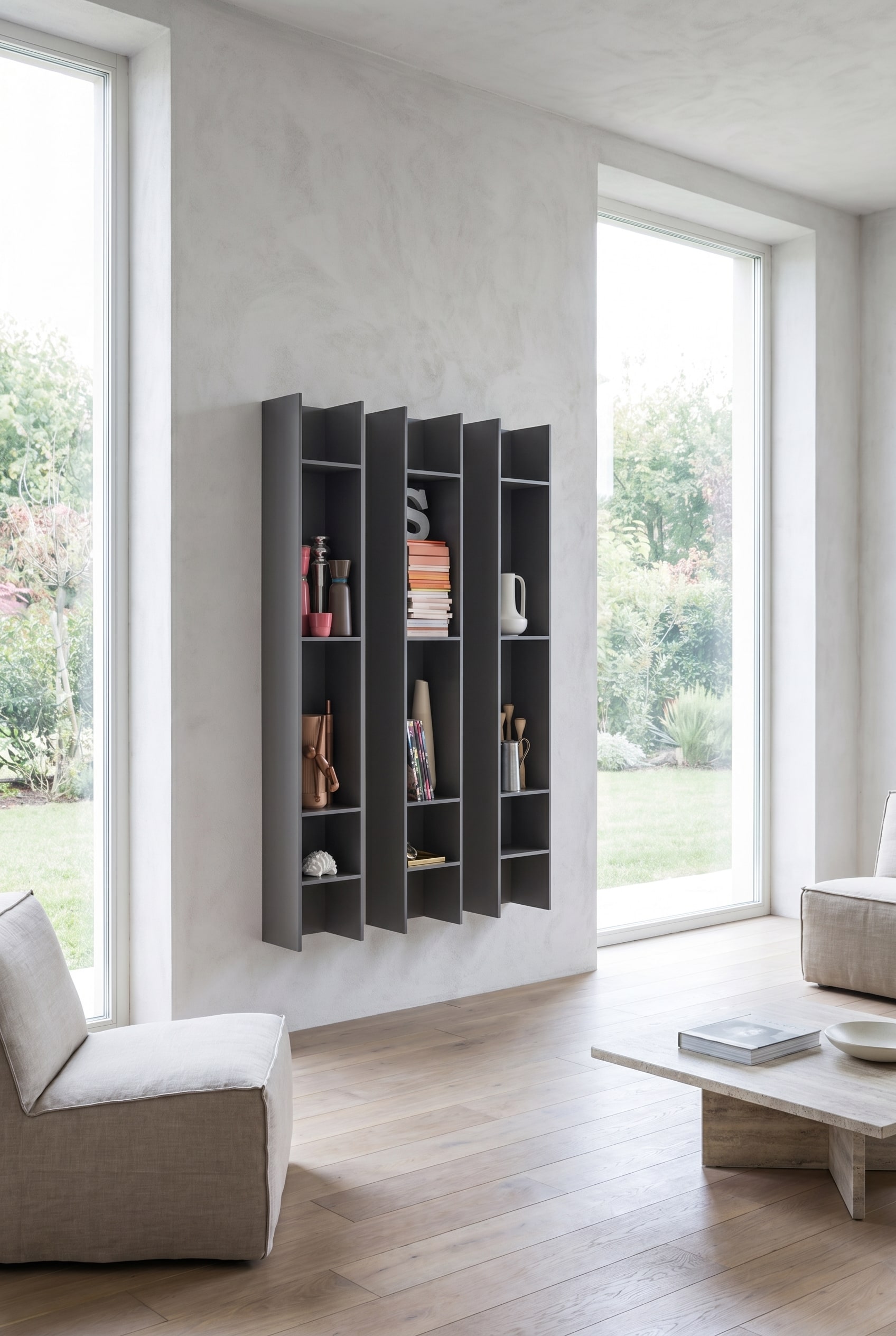 Elegant living room with two narrow, portrait-oriented Novamobili Butterfly wall bookshelves in anthracite, placed asymmetrically next to a large window front