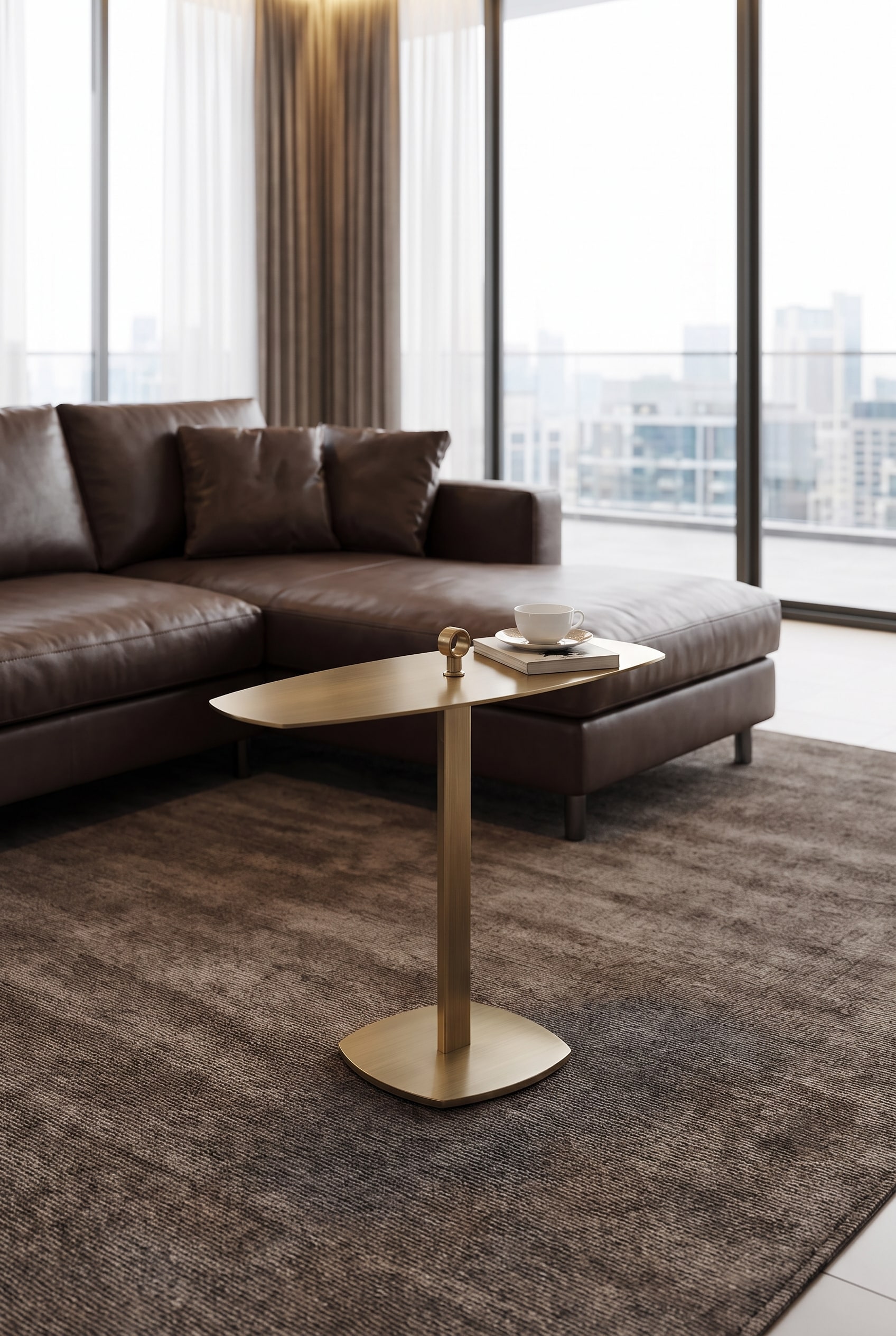 Filigree side table in bronze finish in front of a dark sofa, illuminated by soft side light