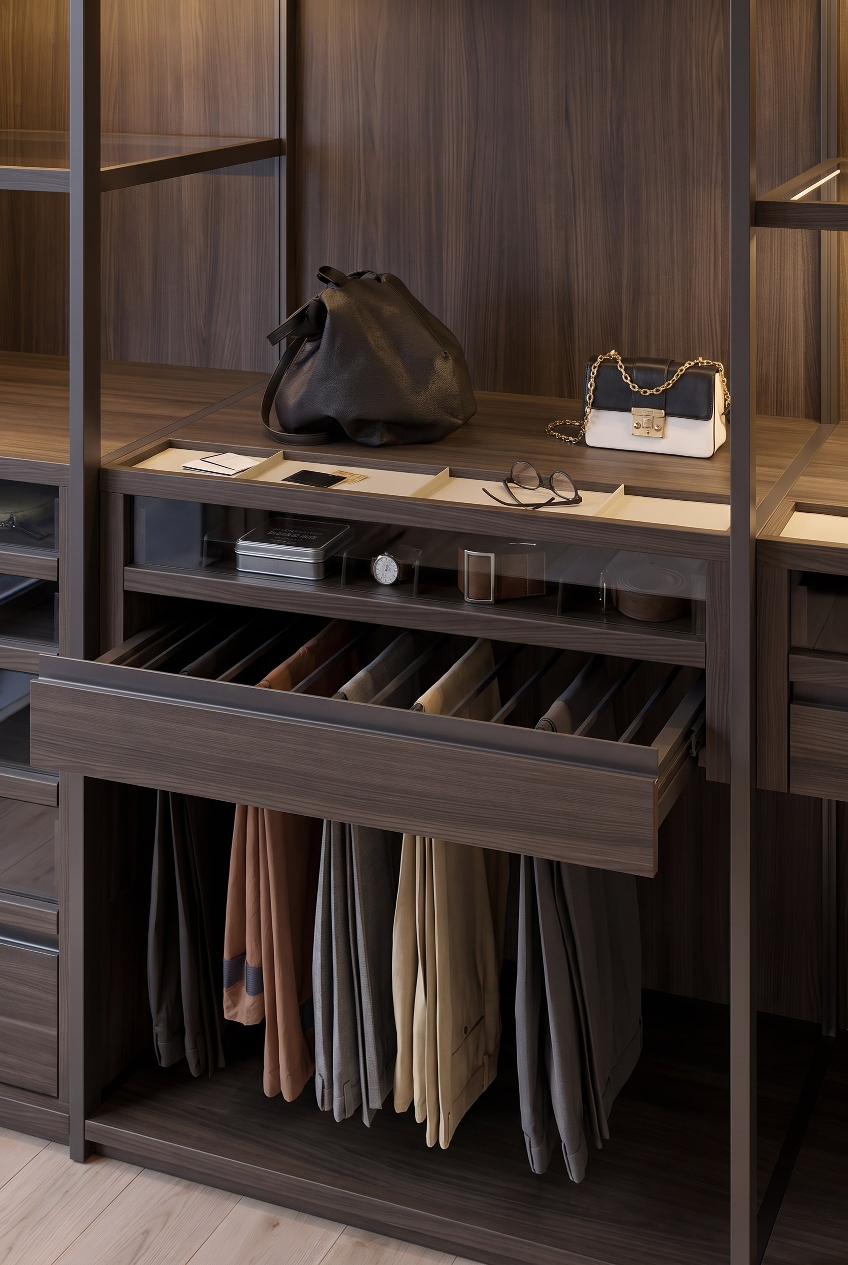 Detailed view of an open drawer in wood decor with an integrated trouser pull-out and a flat accessory tray above it.