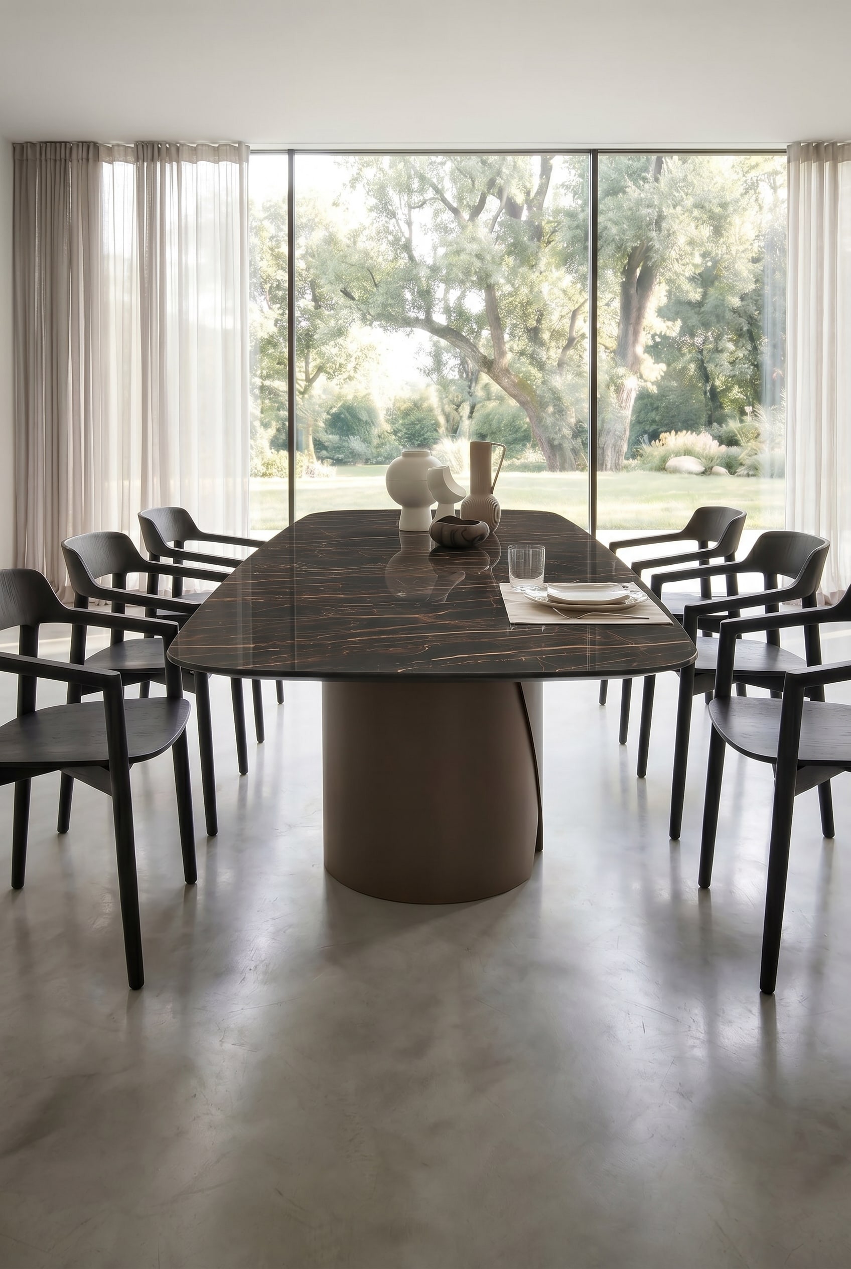 Sculptural round metal leg of the dining table in Brown