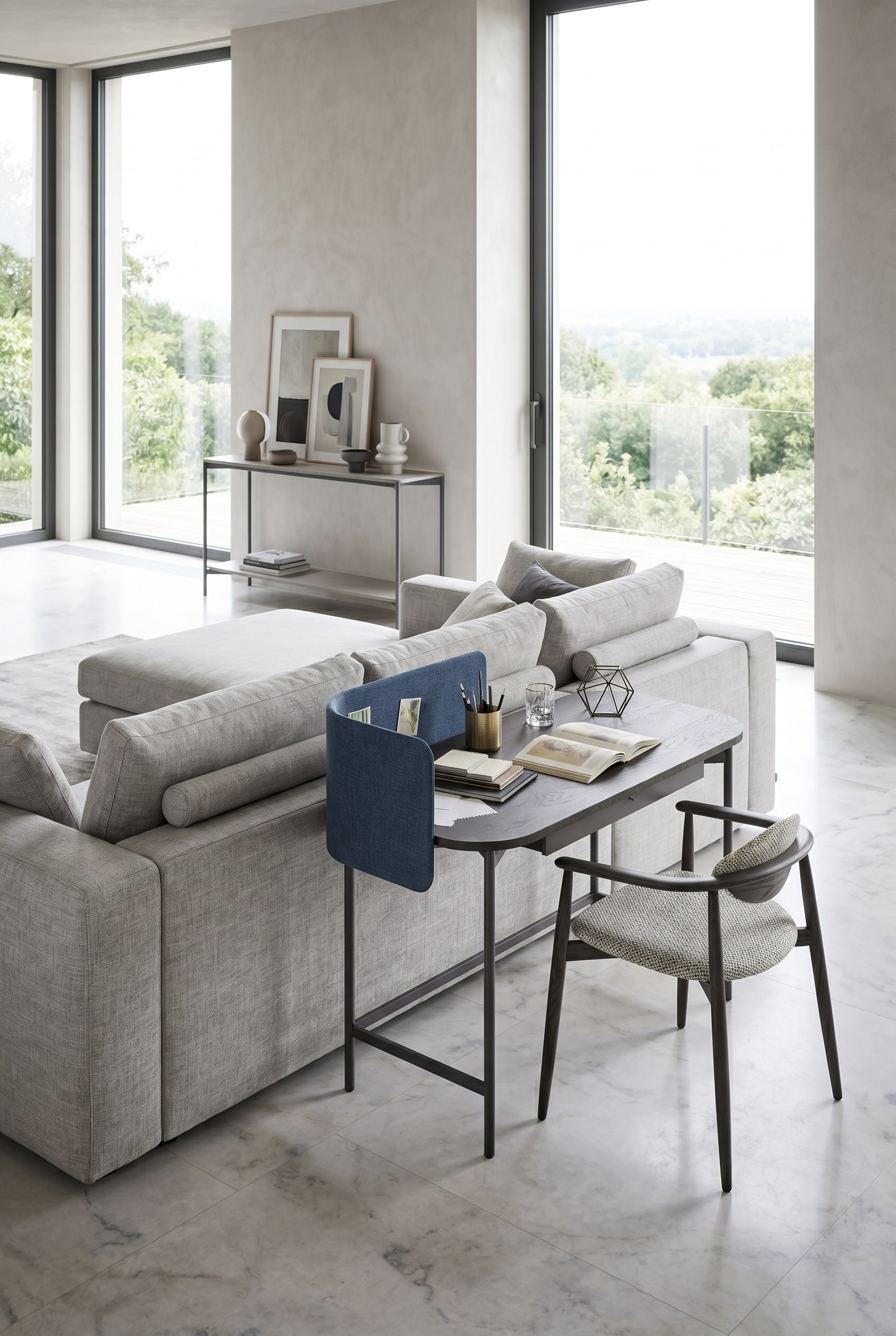 Open living room with dark brown desk, blue privacy panel and grey armchair