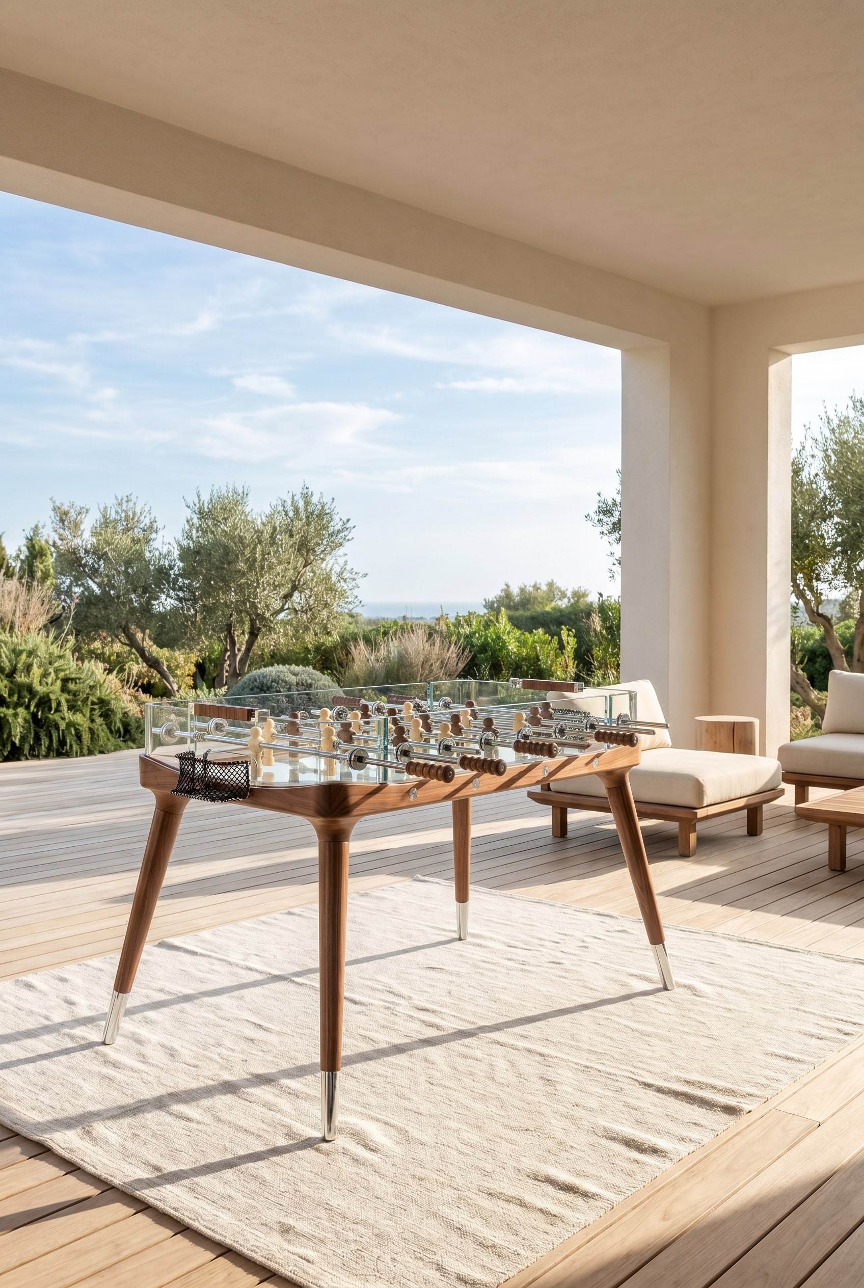 Covered sunny loggia with crystal glass foosball table and elegant walnut legs on light wooden floor
