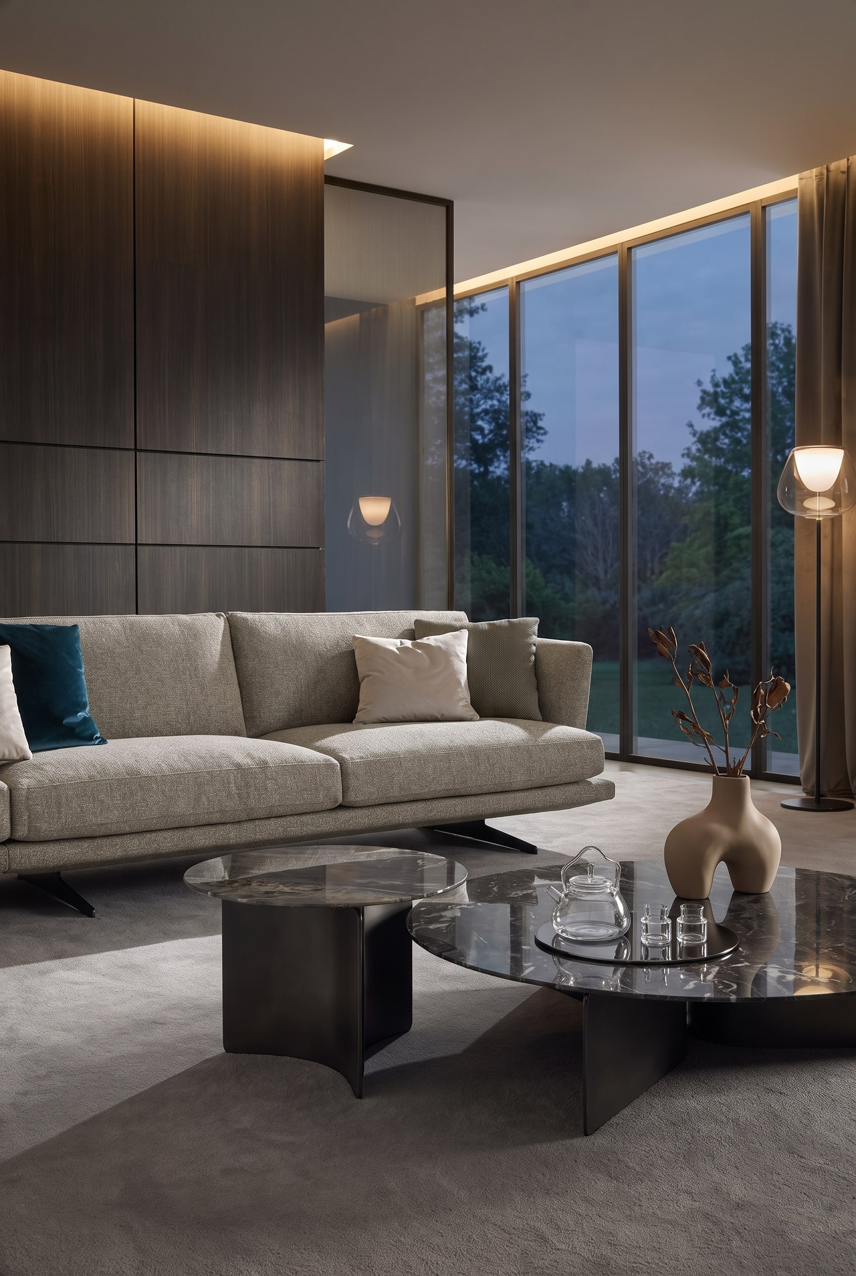 Elegant living room with a wavy, organic coffee table in front of a generous, dark blue velvet sofa, decorated with a bulbous ceramic vase.