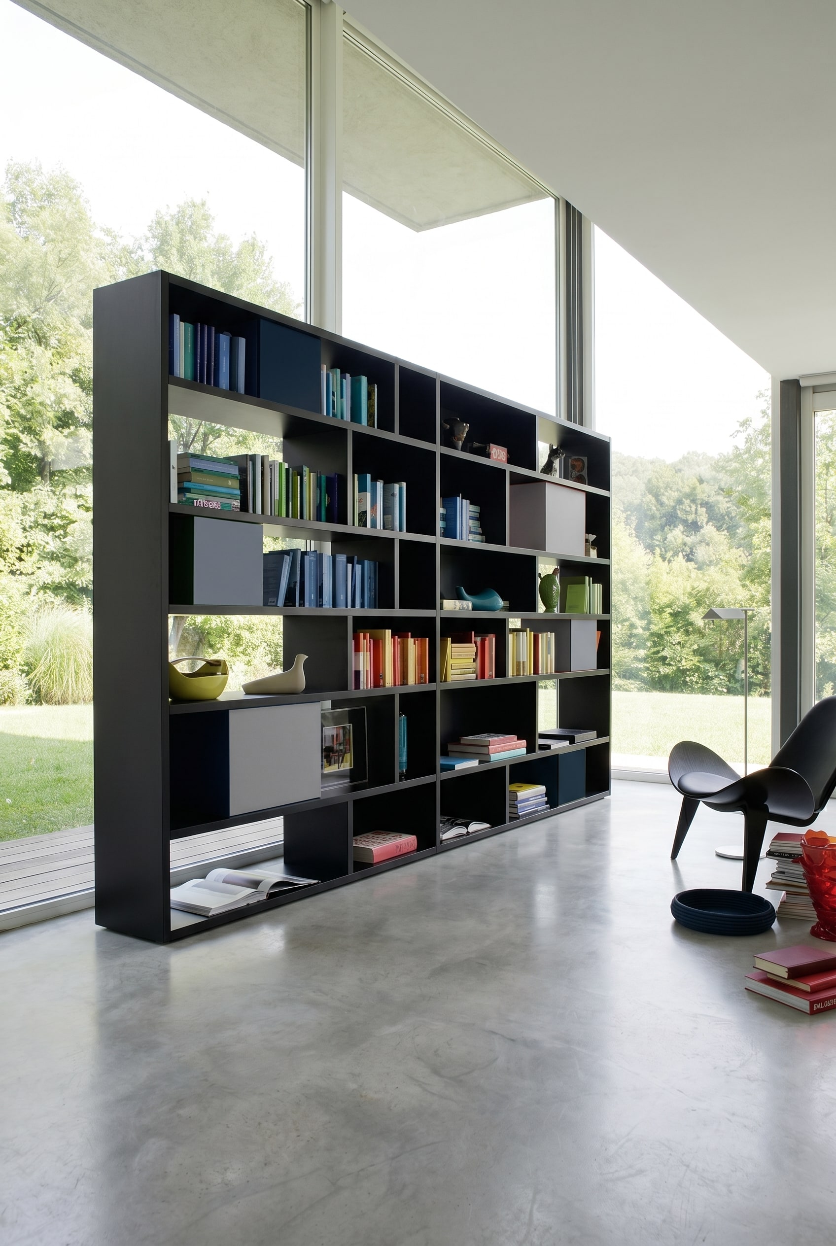 Matte black asymmetrical design shelf with integrated grey and blue storage boxes against white walls