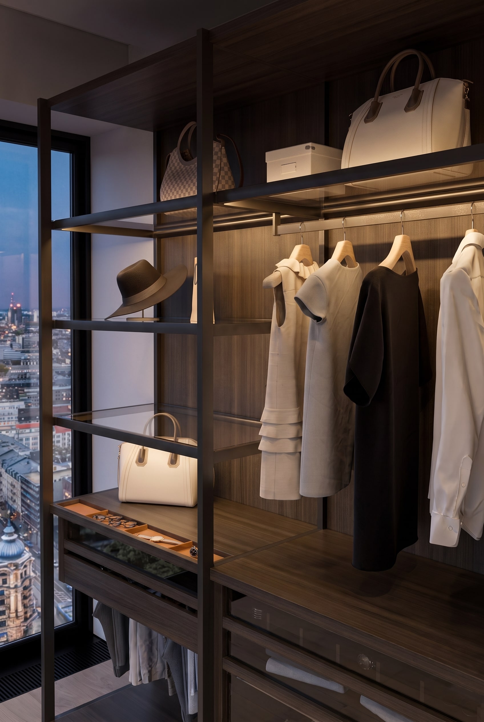 Wardrobe interior with hanging clothes, shirts, and handbags and hats placed on glass shelves.