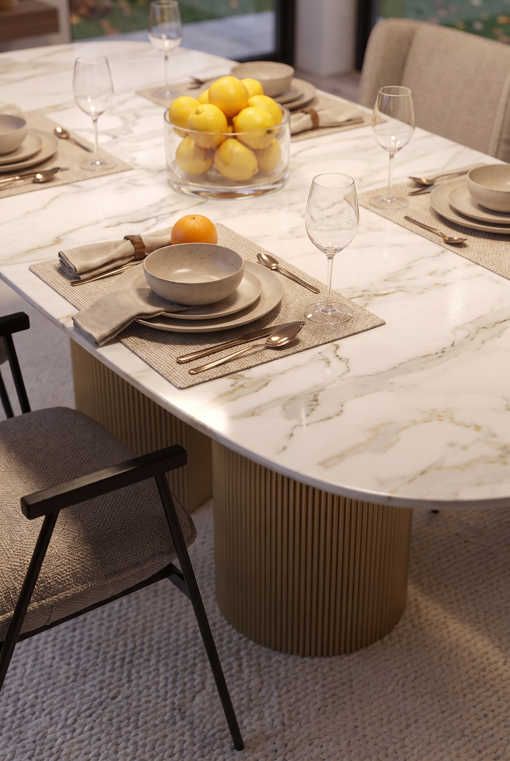 Detail shot of a luxury dining table with dark metal legs and a scratch-resistant ceramic table surface in autumn light, decorated with stoneware and copper cutlery.