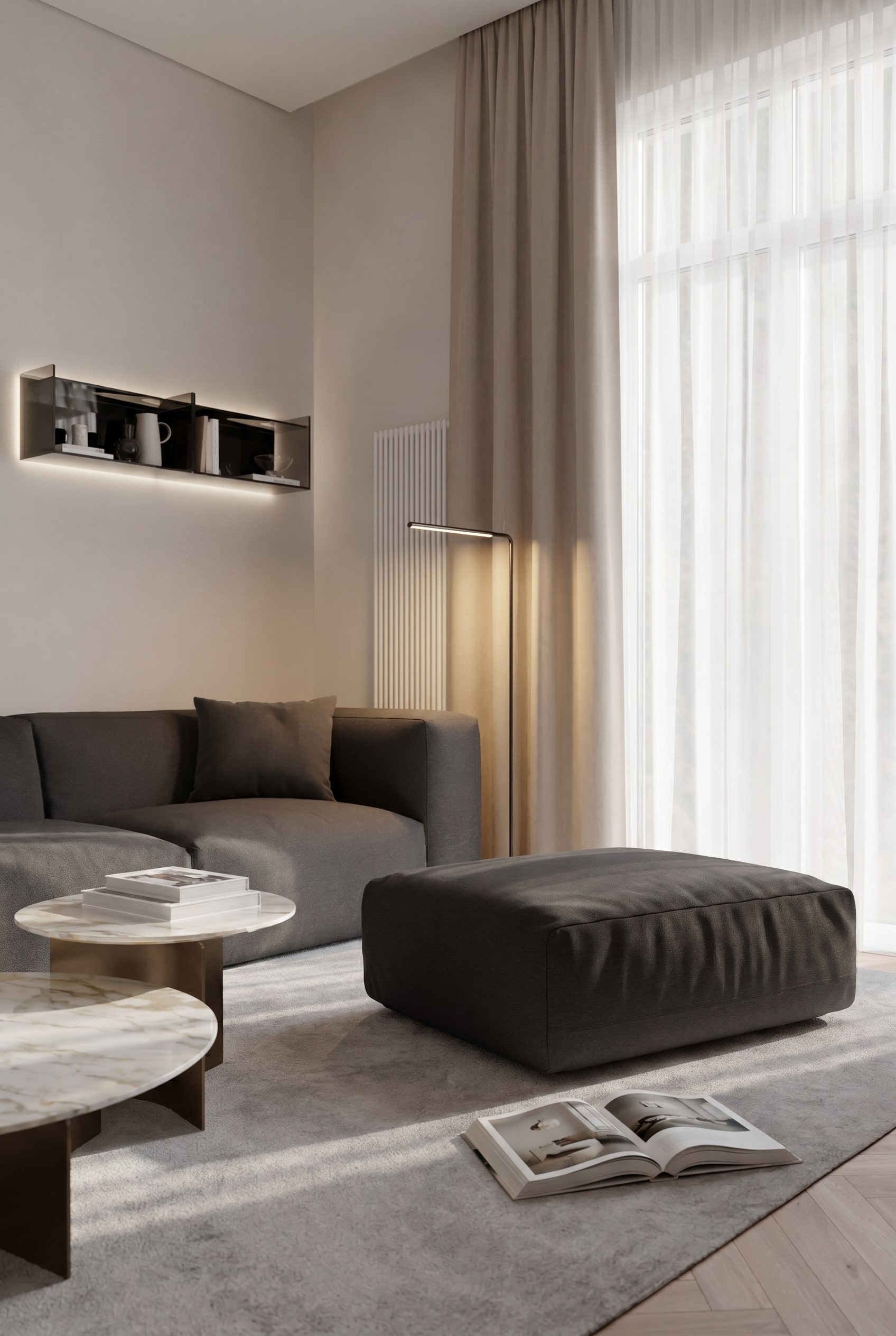 Elegant reading nook with Cloud pouf in dark fabric upholstery, matching recliner, and a slender floor lamp