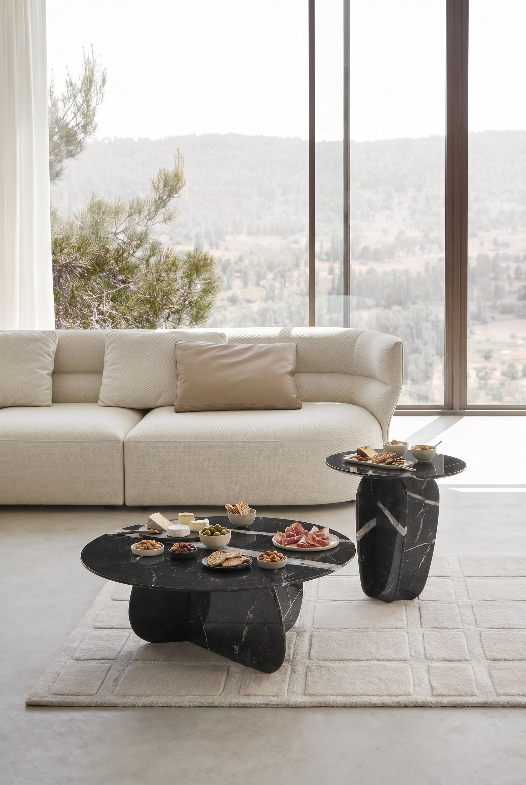 Elegant living room with two round marble coffee tables in front of a beige fabric sofa on a light carpet