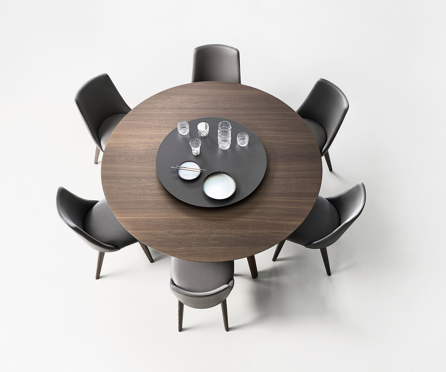 Top view of the Convivio dining table from Livitalia with brown lacquered swivel top and coffee service Top view of the Convivio dining table from Livitalia with brown lacquered swivel top and coffee service