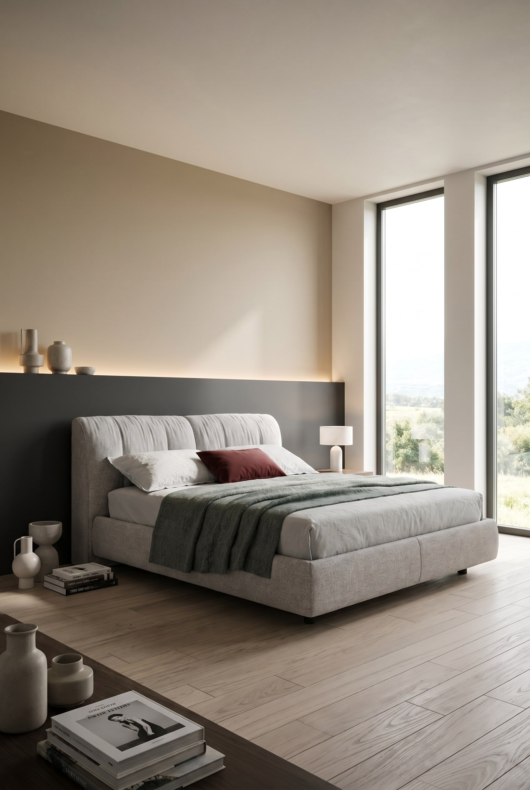 Graues Polsterbett mit Bettkasten vor horizontal zweifarbig gestrichener Wand im modernen Schlafzimmer