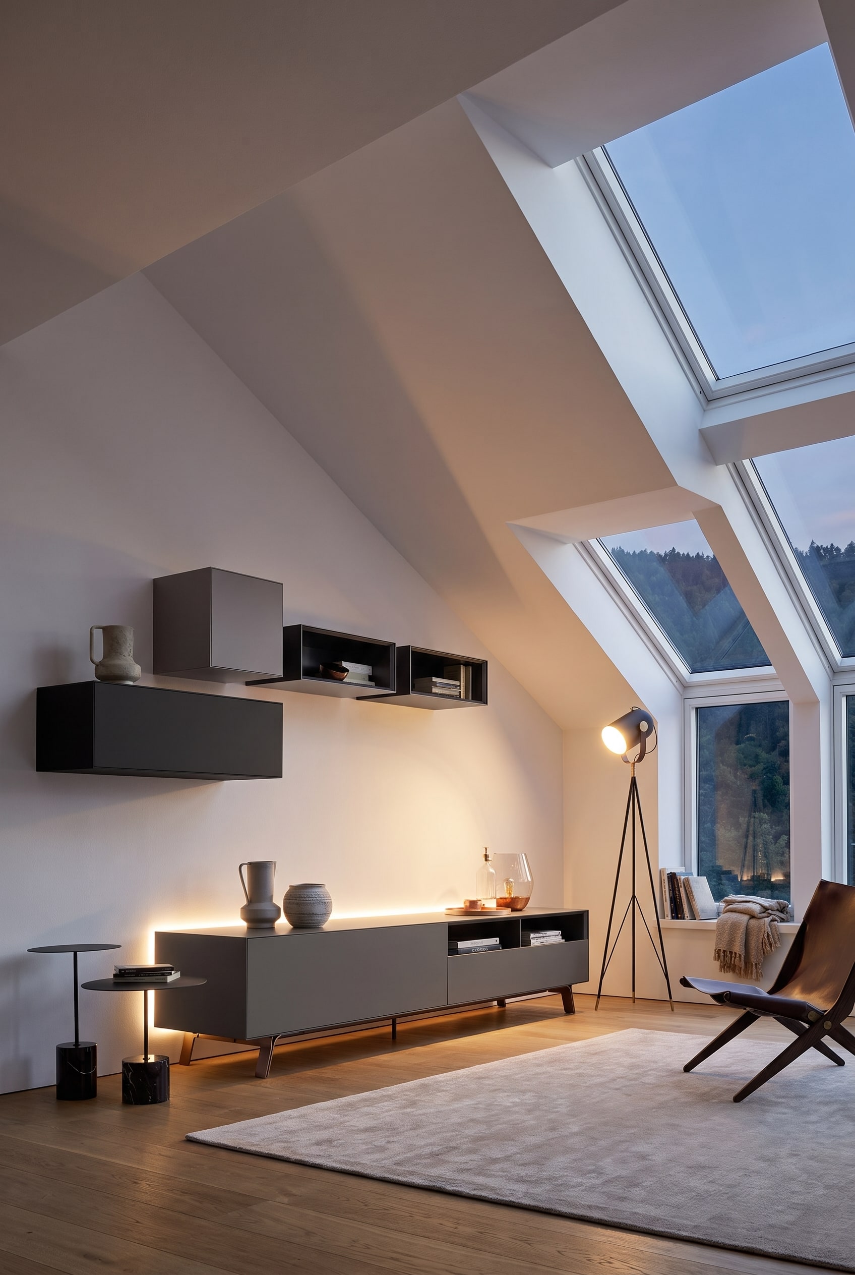 Modular white wall cabinets, adapted in a stepped manner to the slope of an attic ceiling
