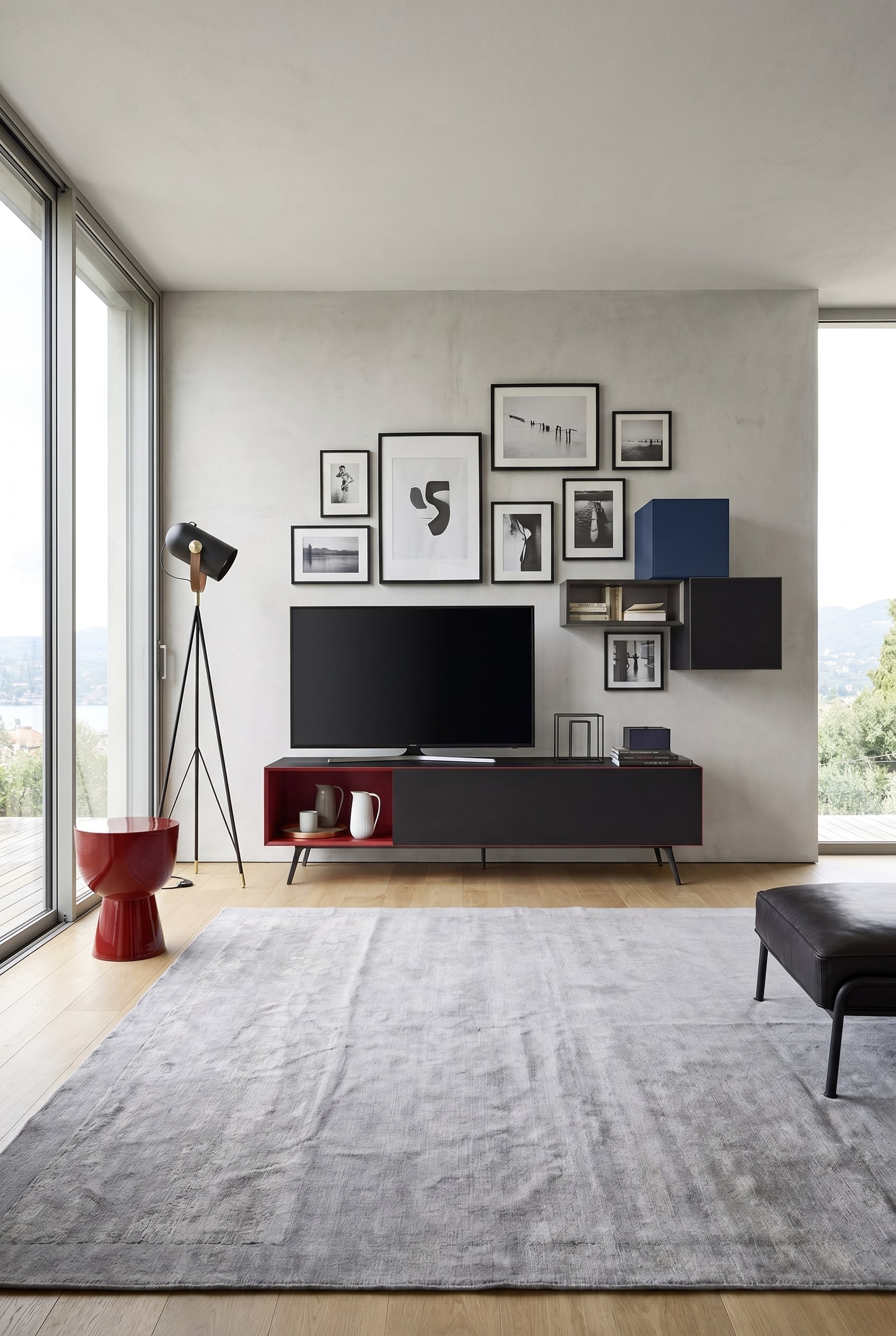 Minimalist lowboard with open red compartments and black fronts under a living room gallery wall